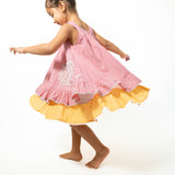 Pocketful of sunsets' sleeveless dress in peach pink with yellow frill in handwoven cotton