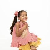 Pocketful of sunsets' sleeveless dress in peach pink with yellow frill in handwoven cotton